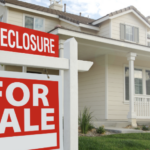 House with For Sale Foreclosure Sign